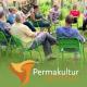 employees of the permaculture institute at a strategy meeting: you see people of different ages and genders sitting on green chairs in a circle on a fresh green meadow. a vegetable garden is indicated in the background and the people in the center of the picture are laughing employees of the permaculture institute at a strategy meeting: you see people of different ages and genders sitting on green chairs in a circle on a fresh green meadow. a vegetable garden is indicated in the background and the people in the center of the picture are laughing